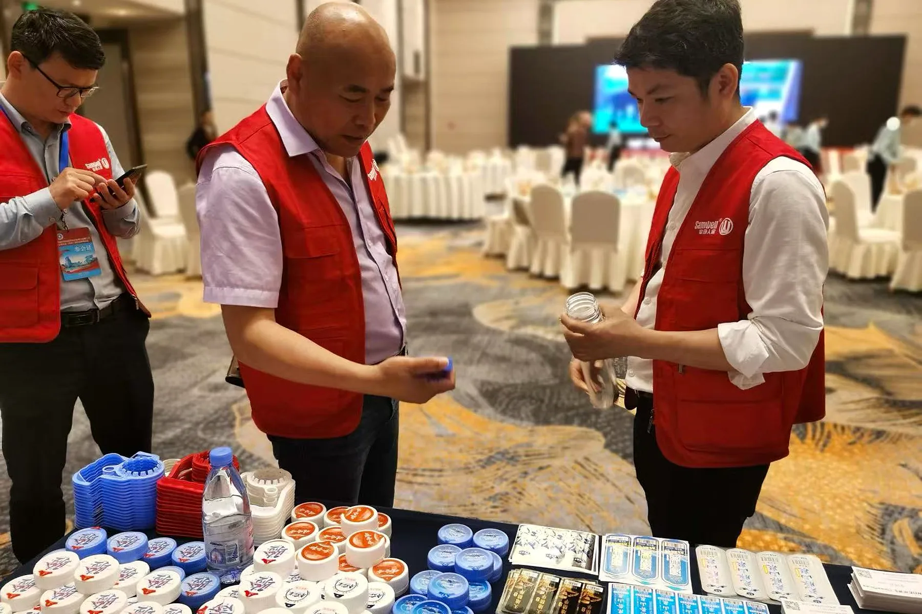 Bottlers checking cap samples at the show