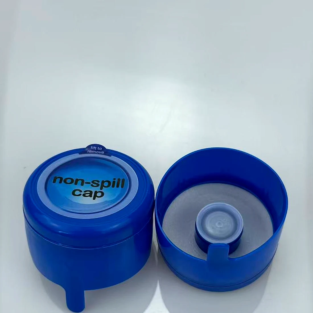 Blue non-spill cap for a 5-gallon water barrel, shown open and closed